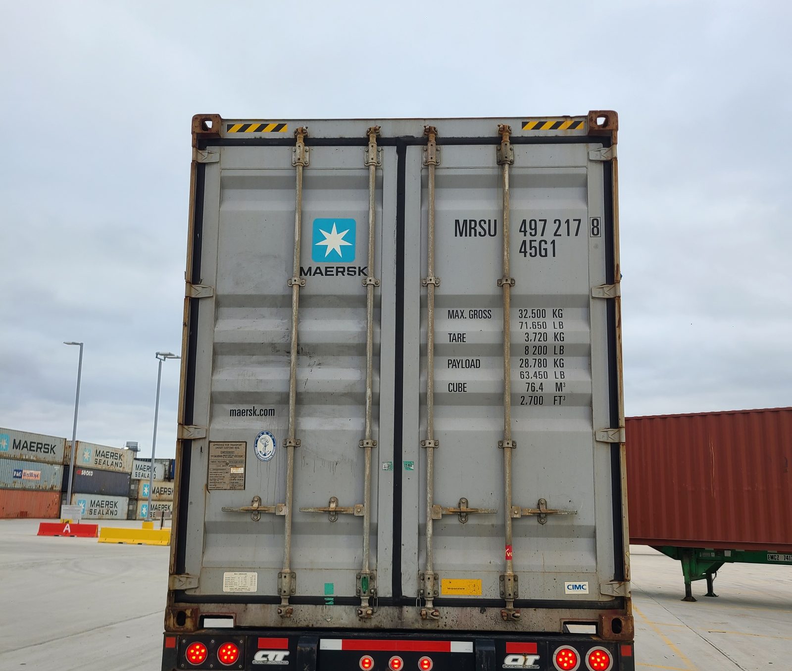 Rear of a CIT gooseneck chassis carrying an ocean container
